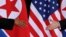 FILE - U.S. President Donald Trump and North Korea's leader Kim Jong Un reach to shake hands at the start of their summit at the Capella Hotel on the resort island of Sentosa, Singapore, June 12, 2018.