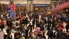 FILE - Travelers gather inside of the Beijing Railway Station in Beijing, Jan. 17, 2020. 