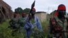 FILE - Sudan People's Liberation Army (SPLA-IO) rebels walk during an assault on government Sudan People's Liberation Army (SPLA) soldiers in the town of Kaya, South Sudan, Aug. 26, 2017.