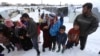 FILE - Syrian refugees gather at a refugee camp in Zahleh, Bekaa Valley, Lebanon, Jan. 8, 2015.