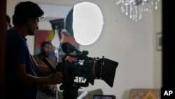 FILE - A cameraman films on the set during the during the shooting of a scene of tv drama serial 'Aadi Si Bewai' or 'Half-hearted,' in Islamabad, Oct. 29, 2024.