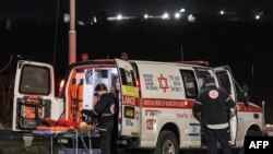 An ambulance is deployed at the scene of a reported car-ramming attack at the Ras Bidu checkpoint near the Israeli settlement of Givat Zeev, between Jerusalem and Ramallah in the occupied West Bank, on January 7, 2024.