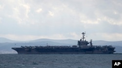 FILE - Aircraft carrier USS Harry S. Truman is moored near Split, Croatia, Feb. 14, 2022.