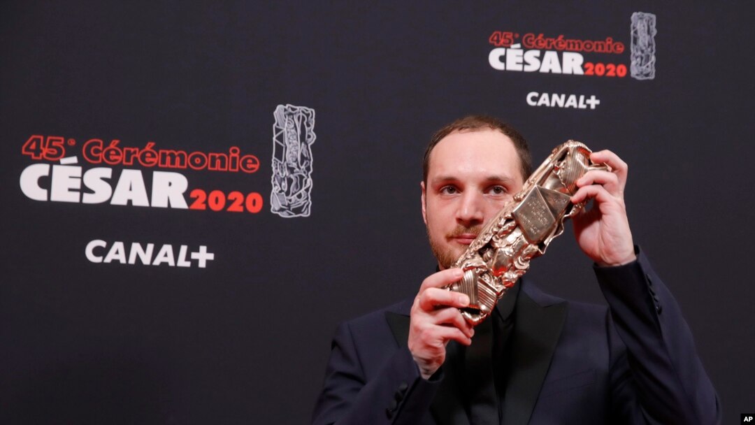Alexis Manenti holds his best male newcomer Cesar award at a ceremony sometimes dubbed "French Oscars," in Paris, France, Feb. 28, 2020.