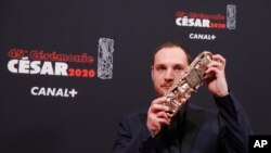 Alexis Manenti holds his best male newcomer Cesar award at a ceremony sometimes dubbed "French Oscars," in Paris, France, Feb. 28, 2020.