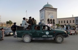 Taliban fighters patrol inside the city of Kandahar, southwest Afghanistan, Aug. 15, 2021.