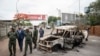 Border officials inspect a burnt-out Mozambican border patrol vehicle at the border crossing in Lebombo, South Africa, Nov. 7, 2024. 