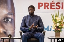 FILE—Presidential candidate for the Diomaye President coalition Bassirou Diomaye Faye gestures during a press conference in Dakar on March 15, 2024.