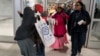 Halima Mohamed, embraces her daughter Muzamil Shalle, 14, left, as her other daughter Miski Shalle, 11, center, approaches. Mohamed sees her children for the first time in seven years in New York, March 8, 2017. The parents, who are from Somalia, but have been living in Mechanicsburg, Pennsylvania, were originally scheduled to receive the children earlier this year, but the process was delayed due to the White House travel ban executive order.