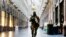 FILE - In this Nov. 26, 2015 file photo, a Belgian Army soldier walks through the Galleries Royal Saint-Hubert in the center of Brussels. 