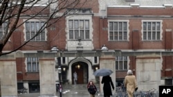 FILE - People walk near the campus center at Princeton University in Princeton, N.J., Dec. 9, 2013. 