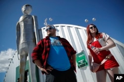 In this Sept. 20, 2019, file photo, Jackson Carter and Veronica Savage wait for passes to enter the Storm Area 51 Basecamp event in Hiko, Nev. (AP Photo/John Locher, File)
