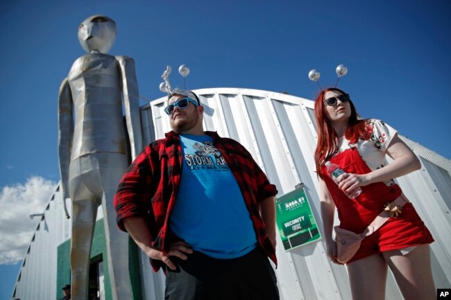 In this Sept. 20, 2019, file photo, Jackson Carter and Veronica Savage wait for passes to enter the Storm Area 51 Basecamp event in Hiko, Nev. (AP Photo/John Locher, File)