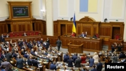 Members of the Ukrainian parliament react during a session after voting on a proposal to terminate a treaty with Russia, in Kyiv, Ukraine Dec. 6, 2018.