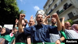 Demonstrators gesture and shout slogans during a protest demanding social and economic reforms, as well as the departure of the country's ruling elite in Algiers, Algeria, Sept. 24, 2019.