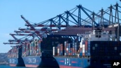 Cargo containers sit stacked on ships at the Port of Los Angeles, Oct. 20, 2021 in San Pedro, California.