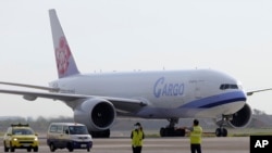 In this photo released by the Taiwan Centers for Disease Control, a China Airlines cargo plane carrying COVID-19 vaccines from Memphis arrive at the airport outside Taipei, June 20, 2021. (Taiwan Centers for Disease Control via AP)