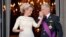Belgium's King Philippe, right, kisses the hand of Queen Mathilde as they stand on the balcony of the royal palace in Brussels. Philippe has taken the oath before parliament to become the country's seventh king after his father Albert abdicated.