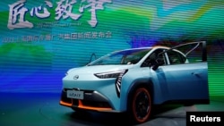 FILE - A GAC Aion Y electric vehicle (EV) is seen displayed at a booth of GAC Group during a media day for the Auto Shanghai show in Shanghai, China, April 19, 2021. 