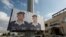 FILE - Two posters with pictures of Jordanian pilot Lt. Muath al-Kaseasbeh hang on a street pole, in front of the pilot's tribal gathering place, in Amman, Jordan,