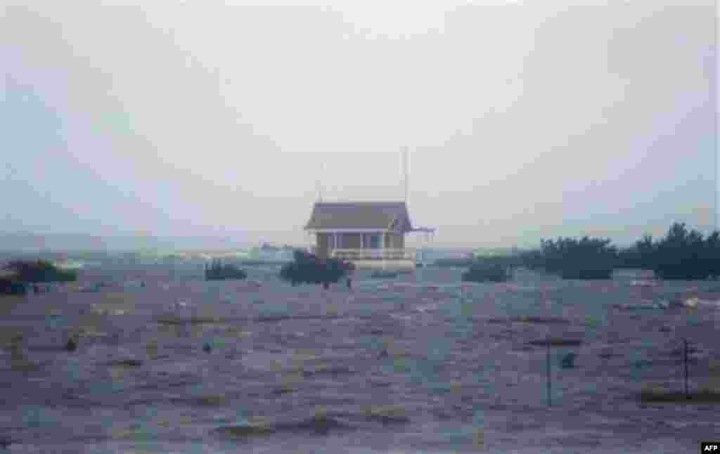 Floodwaters rise at dusk from the Albemarle Sound on the Outer Banks in Nags Head, N.C., Saturday, Aug. 27, 2011 as Hurricane Irene leaves the North Carolina coast. Hurricane Irene knocked out power and piers in North Carolina, clobbered Virginia with win