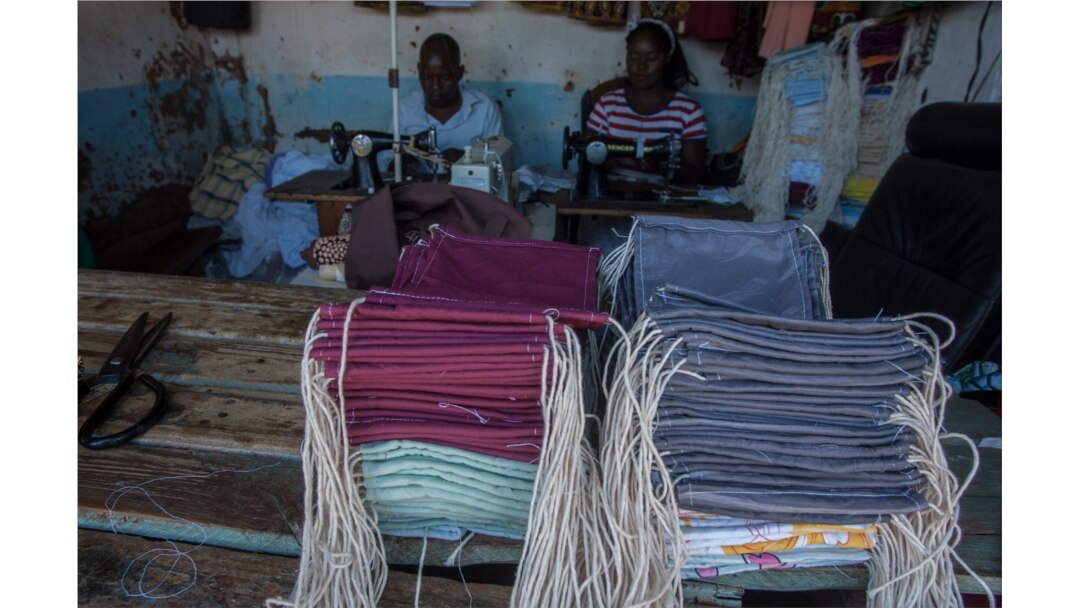 FILE - Tailors make face masks at the Tayamba Tailoring shop, which has embarked in the business of producing face masks intended to protect against the COVID-19 coronavirus, in Lilongwe, Malawi, May 4, 2020.