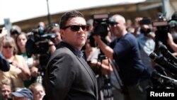 FILE - Unite The Right rally organizer Jason Kessler attempts to speak at a press conference in front of Charlottesville City Hall in Charlottesville, Virginia, Aug. 13, 2017. 