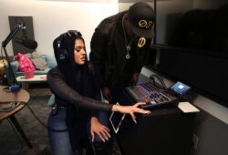 Amani Al-Khatahtbeh, founder of Muslimgirl.com, left, and a potential podcast cohost, OD, start recording their pilot in a Spotify studio, Dec. 19, 2019 in New York.