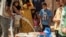 FILE - Residents fill up buckets with water from cisterns provided by humanitarian organisations during water shortages in Syria's northeastern city of Hasakah, Aug. 22, 2020.