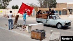 Protesters, who are demanding jobs and a share in revenue from the area's natural resources, block the road usually used by foreign oil companies to go the oil field in Tataouine, Tunisia, May 12, 2017. Picture taken May 12, 2017. 