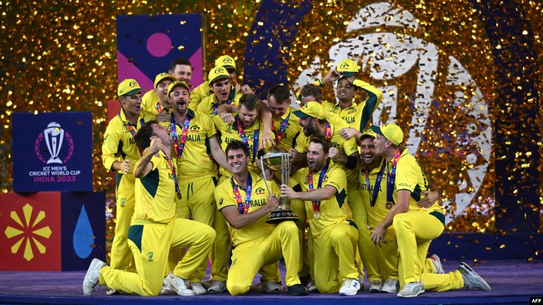 Australia's players celebrate with the trophy after winning the 2023 ICC Men's Cricket World Cup one-day international (ODI) final match against India at the Narendra Modi Stadium in Ahmedabad on November 19, 2023. (Photo by Punit PARANJPE / AFP) / -- IMA