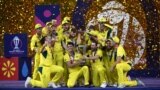 Australia's players celebrate with the trophy after winning the 2023 ICC Men's Cricket World Cup one-day international (ODI) final match against India at the Narendra Modi Stadium in Ahmedabad on November 19, 2023. (Photo by Punit PARANJPE / AFP) / -- IMA