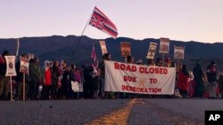 Demonstrators block a road at the base of Hawaii's tallest mountain, in Mauna Kea, to protest the construction of a giant telescope on land that some Native Hawaiians consider sacred. July 15, 2019.