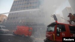 Firefighters put out a fire at the Duroy hotel following a bomb attack, in Raouche, in western Beirut, Lebanon, June 25, 2014.