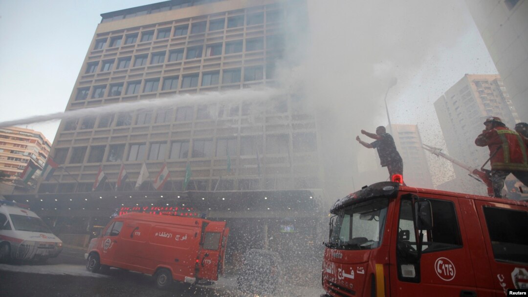 Firefighters put out a fire at the Duroy hotel following a bomb attack, in Raouche, in western Beirut, June 25, 2014.