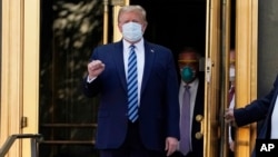 FILE - President Donald Trump walks out of Walter Reed National Military Medical Center to return to the White House after receiving treatments for COVID-19 in Bethesda, Md., Oct. 5, 2020.