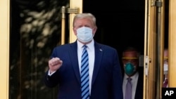 FILE - President Donald Trump walks out of Walter Reed National Military Medical Center to return to the White House after receiving treatments for COVID-19 in Bethesda, Md., Oct. 5, 2020.