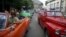 Tourists enjoy a ride in vintage cars in old Havana, Cuba, Jan. 17, 2016. 