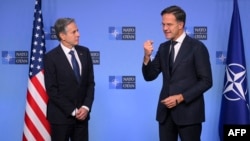 NATO's Secretary General Mark Rutte, right, gestures as he speaks with U.S. Secretary of State Antony Blinken during a NATO Foreign Ministers' meeting at the NATO headquarters in Brussels, on Dec. 3, 2024.