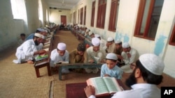 An undated photo of Pakistani children studying the Quran at a religious school in Lahore, Pakistan. Pakistan's religious schools, or madrassas, face renewed scrutiny with many alleging that the schools serve as breeding grounds for violent extremists.