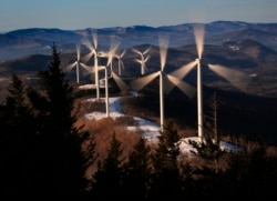 FILE - The blades of wind turbines catch the breeze at the Saddleback Ridge wind farm in Carthage, Maine, March 19, 2019.