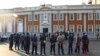 FILE: Police gather outside the Constitutional Court after the court upheld Zimbabwean President Emmerson Mnangagwa' s narrow victory in Harare, Friday, August, 24, 2018. Zimbabwe's constitutional court on Friday unanimously upheld President Emmerson Mnangagwa's narrow victory.