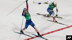 FILE - Jessie Diggins, left, of the United States celebrates after winning the gold medal past Stina Nilsson of Sweden in the women's team sprint freestyle cross-country skiing final at the 2018 Winter Olympics in Pyeongchang, South Korea, Feb. 21, 2018. 