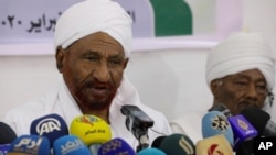 FILE - Former Sudanese Prime Minister Sadiq al-Mahdi, left, leader of the Umma political party, speaks during a press conference in Khartoum, Feb. 6, 2020.