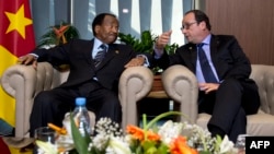 FILE - French president Francois Hollande (R) talks to Cameroon's president Paul Biya, on November 30, 2014, in Dakar, as part of the 15th International Organization of French-Speakers (Francophonie) summit. 