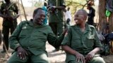 FILE - South Sudan's rebel leader Riek Machar (L) and his wife Angelina Teny joke in front of their tent in a rebel-controlled area in Jonglei State, South Sudan, Jan. 31, 2014.