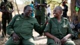 FILE - South Sudan's rebel leader Riek Machar, left, and his wife, Angelina Teny, joke in front of their tent in a rebel-controlled area in Jonglei State, South Sudan, Jan. 31, 2014.