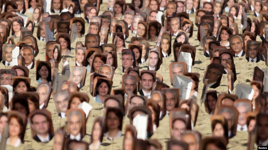 Multiple pictures of Baha'i religious leaders arrested in Iran are seen during a protest at Copacabana Beach in Rio de Janeiro, Brazil, June 19, 2011. 