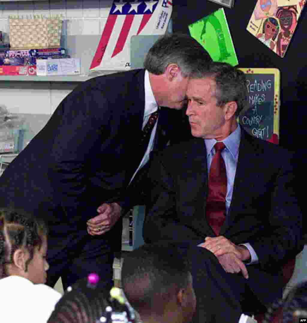 President Bush's Chief of Staff Andy Card whispers into the ear of the President to give him word of the plane crashes into the World Trade Center, during a visit to the Emma E. Booker Elementary School in Sarasota, Fla., Tuesday, Sept. 11, 2001. (AP Pho