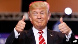President Donald Trump reacts before speaking at a rally at the Phoenix Convention Center, Aug. 22, 2017, in Phoenix. 